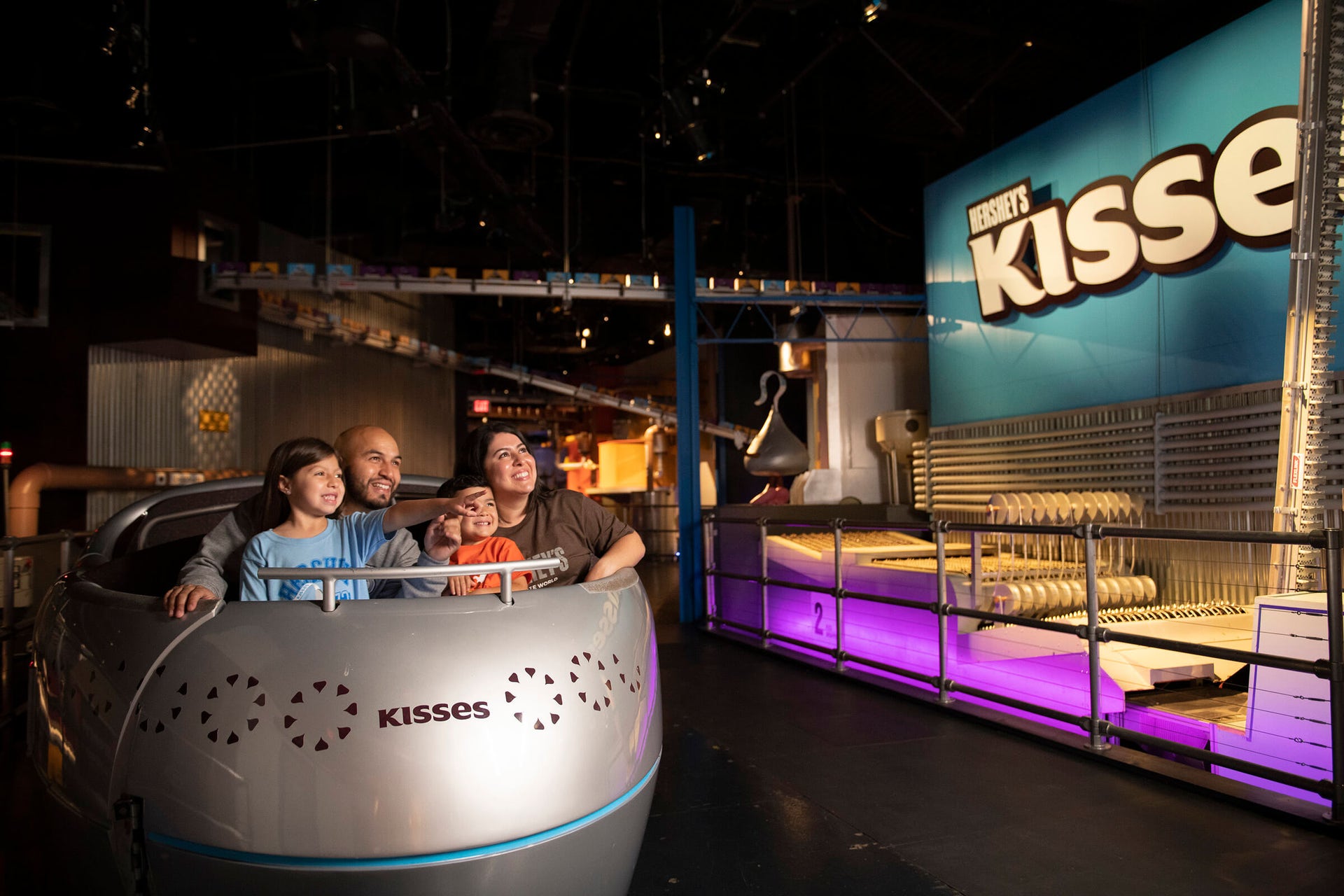 family experiencing the hersheys chocolate tour ride at hersheys chocolate world