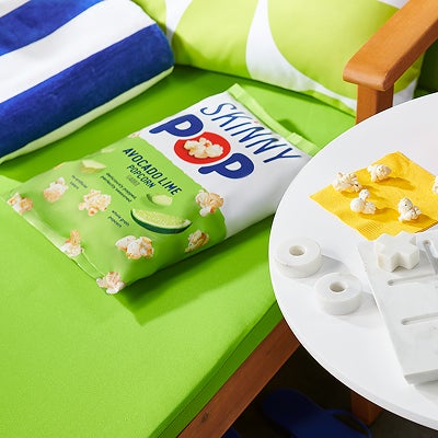 bag of skinnypop avocado lime on pool chair